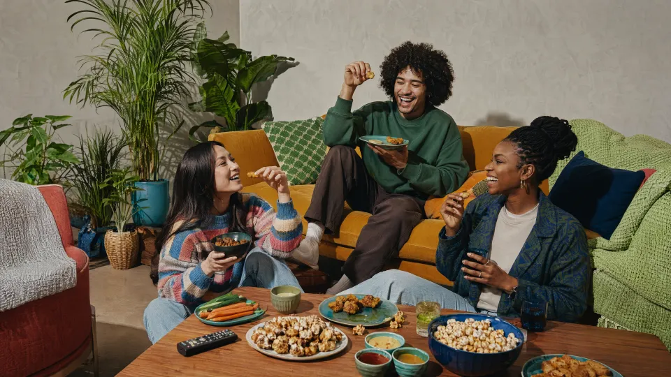 Friends enjoying a movie night with snacks at home